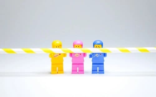3 legos holding a straw