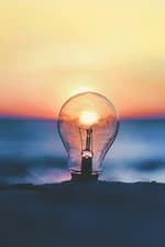 Light on the beach with the sea and a sunset in the background.